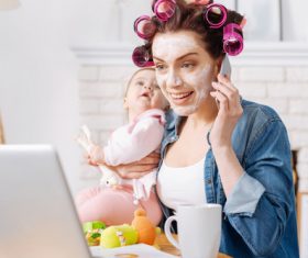 Mother holding child answering the phone Stock Photo 02