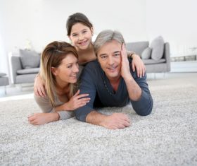 Parents and children lying on the carpet Stock Photo