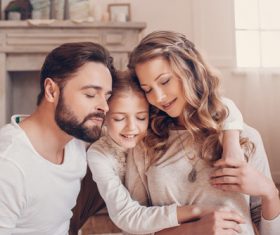 Parents embracing children Stock Photo