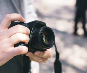 Person holding the camera and pressing the shutter Stock Photo