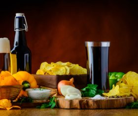 Potato chips and beer and onions Stock Photo