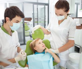 Small patients and dentists and nurses in the dental clinic Stock Photo