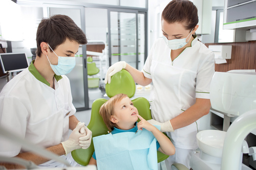 Small patients and dentists and nurses in the dental clinic Stock Photo