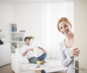 Smiling hostess opening the door Stock Photo 02