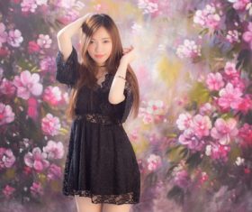 Standing beautiful girl in front of art painting Stock Photo