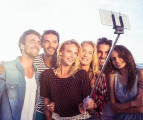Standing on the beach young friends selfie Stock Photo
