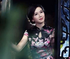Stock Photo Asian cheongsam girl standing in front of the window