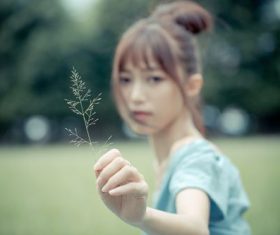 Stock Photo Asian girl holding a leaf