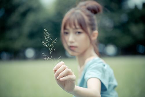 Stock Photo Asian girl holding a leaf