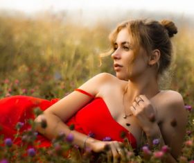Stock Photo Beautiful woman posing in the flowers