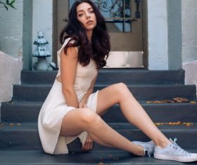 Stock Photo Girl sitting at the door of the house