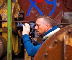 Stock Photo Male photographer shooting abandoned factory building