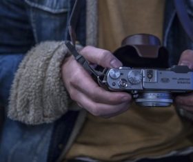 Stock Photo Man looking down at the camera in his hand