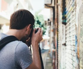 Stock Photo Man with camera taking street scene