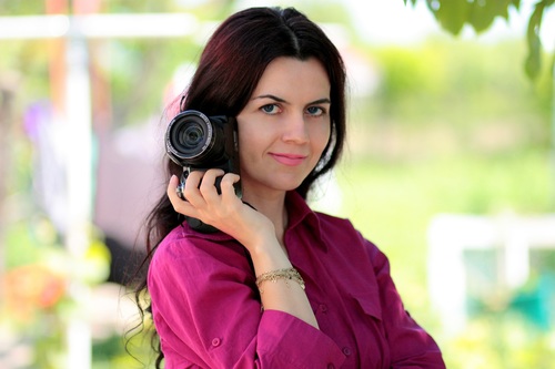 Stock Photo Middle aged woman holding a camera