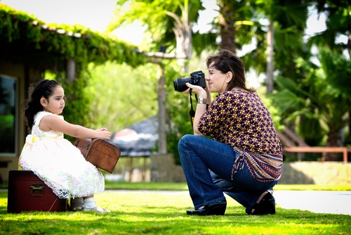 Stock Photo Mother takes photos of her baby