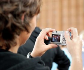 Stock Photo Mother uses digital camera to shoot childrens sports