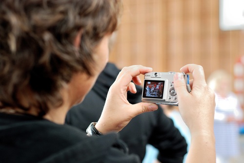 Stock Photo Mother uses digital camera to shoot childrens sports