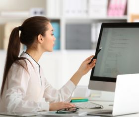 Stock Photo Young female programmer working in the office 01