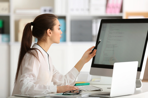 Stock Photo Young female programmer working in the office 01