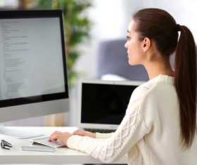 Stock Photo Young female programmer working in the office 09