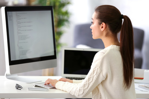 Stock Photo Young female programmer working in the office 09