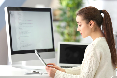 Stock Photo Young female programmer working in the office 10