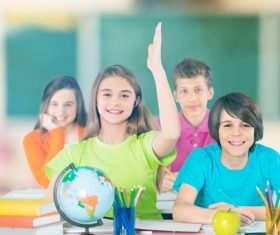 Students raise their hands in class Stock Photo