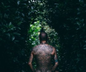 Stylish man with full tattoo on back Stock Photo