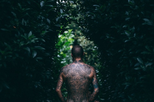 Stylish man with full tattoo on back Stock Photo