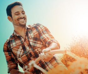 The man watering the garden Stock Photo