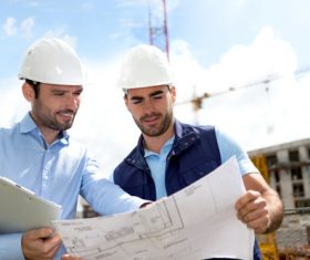 Two men looking at drawings Stock Photo