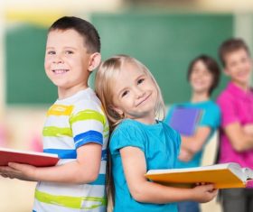 Two pupils opening books Stock Photo