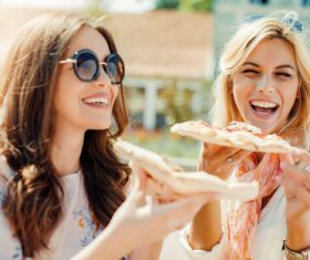 Two woman eating pizza Stock Photo 02