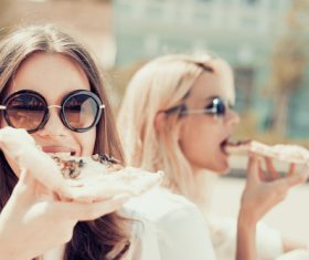 Two woman eating pizza Stock Photo 03