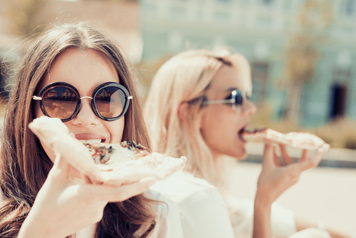 Two woman eating pizza Stock Photo 03