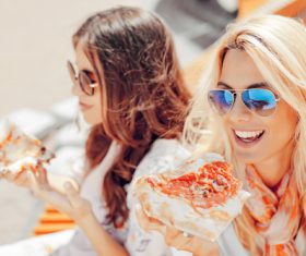 Two woman eating pizza Stock Photo 04