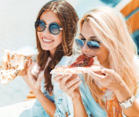 Two woman eating pizza Stock Photo 05