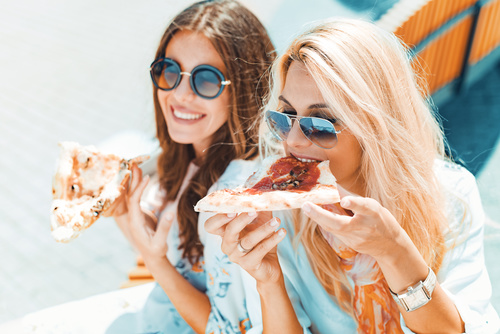 Two woman eating pizza Stock Photo 05