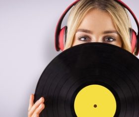 Wearing headphones girl holding a vinyl record Stock Photo 02