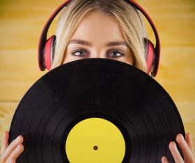 Wearing headphones girl holding a vinyl record Stock Photo 06