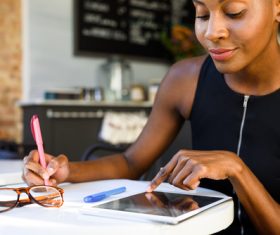 Woman Uses tablets pc to find learning materials Stock Photo