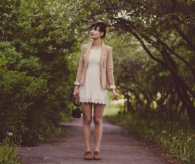 Woman admiring the scenery of the roadside woods Stock Photo