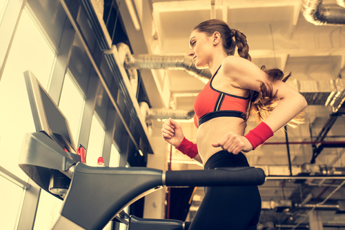 Woman doing aerobic exercise on treadmill Stock Photo