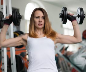 Woman doing exercise with arms Stock Photo