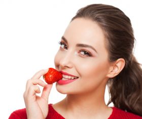 Woman eating strawberry Stock Photo