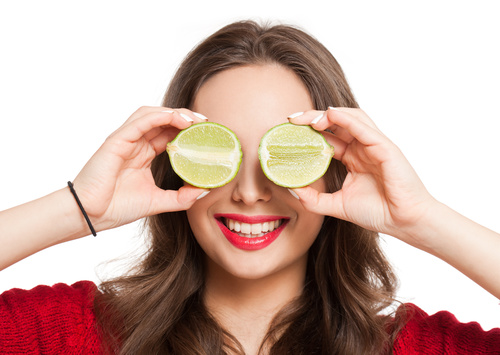 Woman holding cut lemon Stock Photo