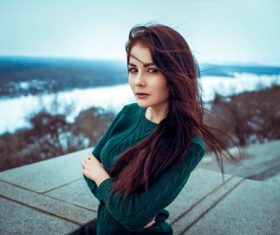 Woman in sweater posing outdoors Stock Photo