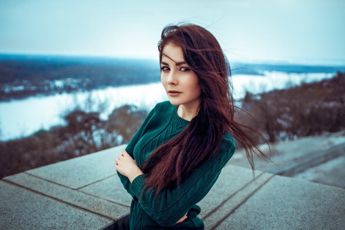 Woman in sweater posing outdoors Stock Photo