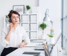 Woman making a call in the office Stock Photo